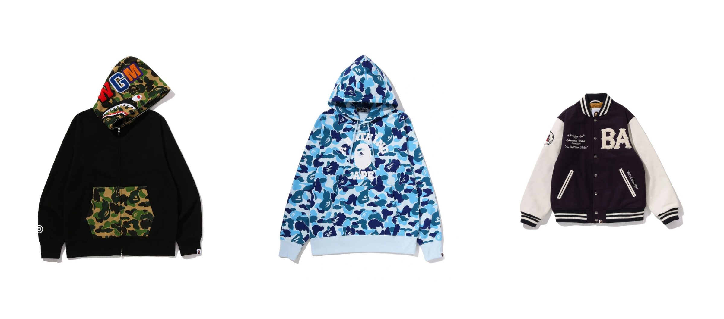 Three Bape pieces side by side: a black ABC camo shark full-zip hoodie, a blue ABC camo pullover hoodie and a purple varsity jacket